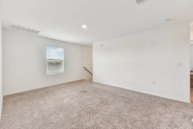 an empty room with a empty space and windows