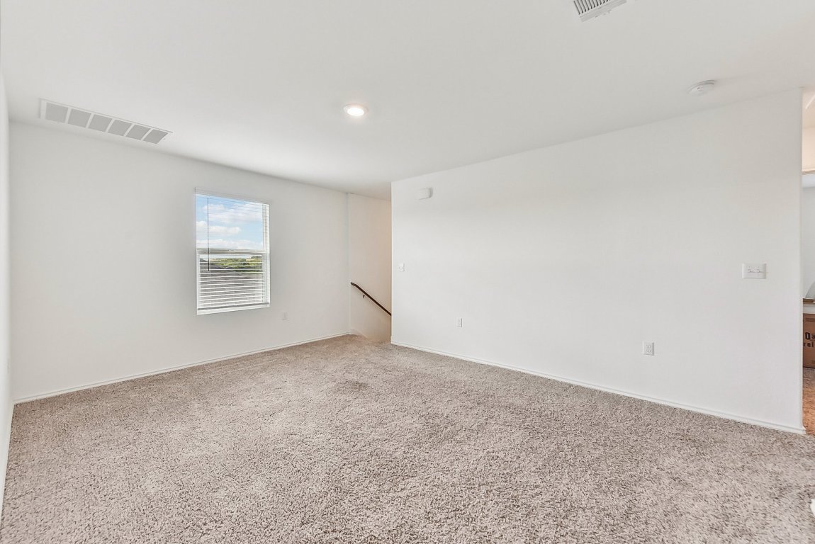 5908 Eden Drive Austin, TX 78747 - Photo 21 of 31 an empty room with a empty space and windows