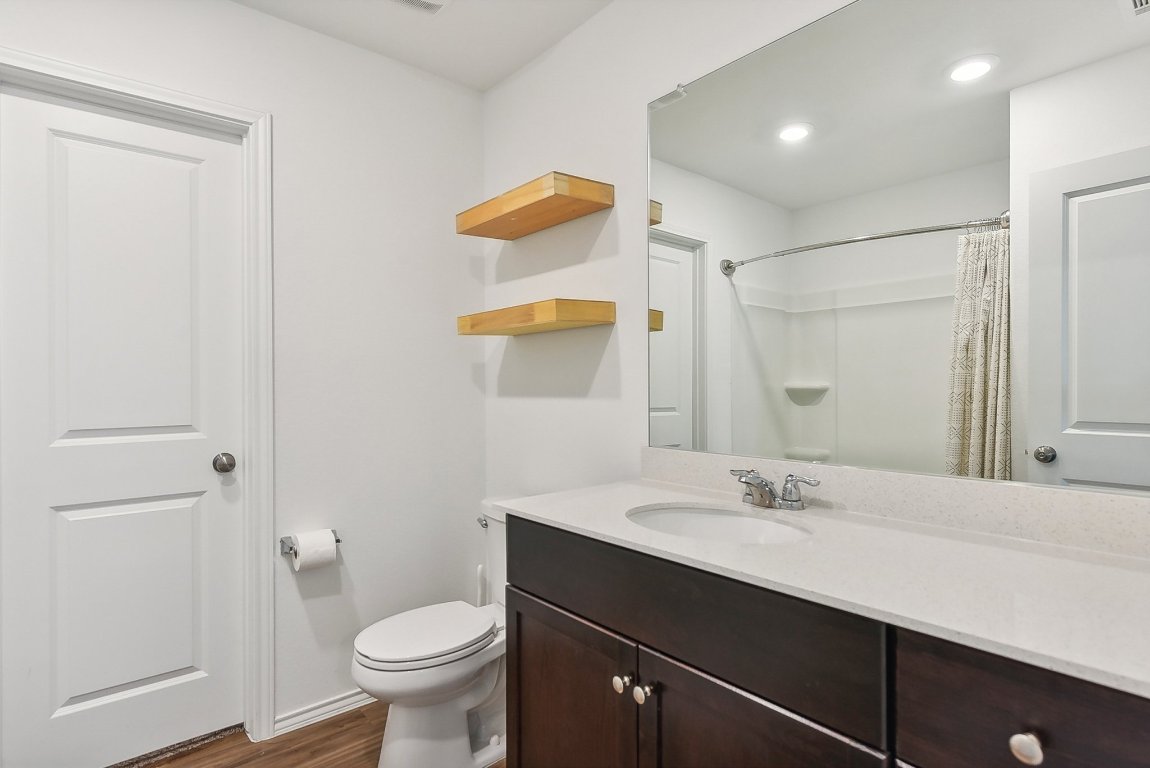 5908 Eden Drive Austin, TX 78747 - Photo 23 of 31 a bathroom with a sink and a mirror