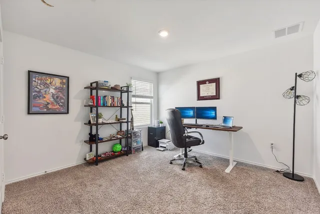 a view of a workspace with furniture