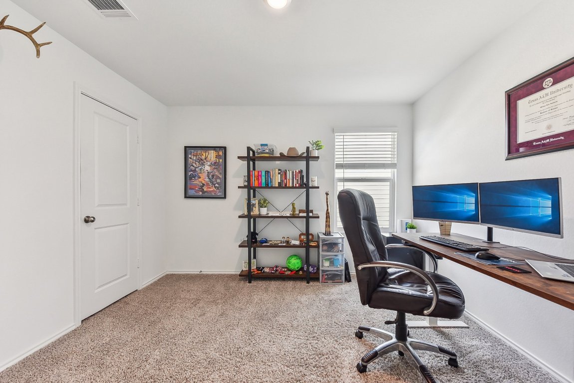5908 Eden Drive Austin, TX 78747 - Photo 27 of 31 a view of a workspace with furniture and a window