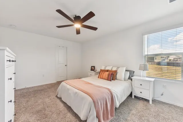 a bedroom with a large bed and a window
