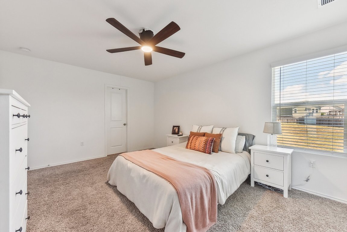5908 Eden Drive Austin, TX 78747 - Photo 28 of 31 a bedroom with a large bed and a window