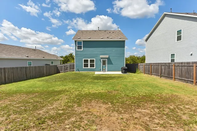 a view of a house with backyard and porch