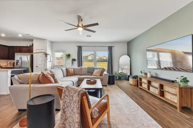 a living room with furniture and a large window