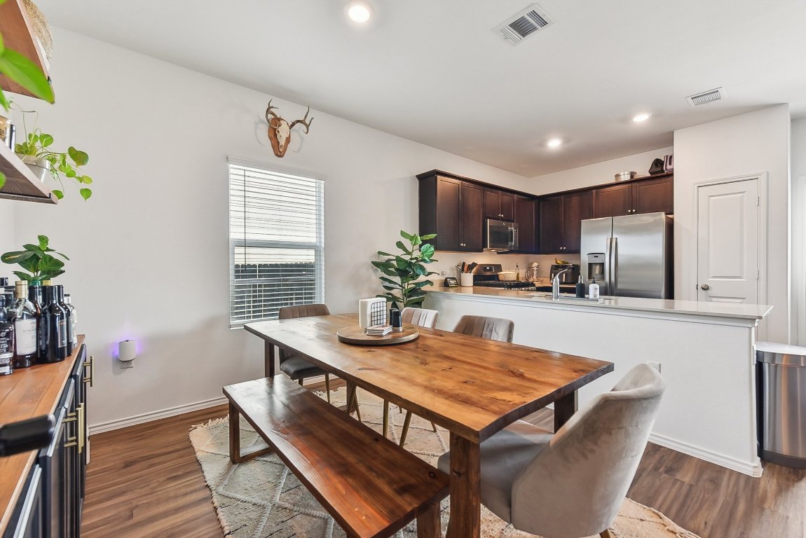 5908 Eden Drive Austin, TX 78747 - Photo 6 of 31 a kitchen with kitchen island a stove a table and chairs in it