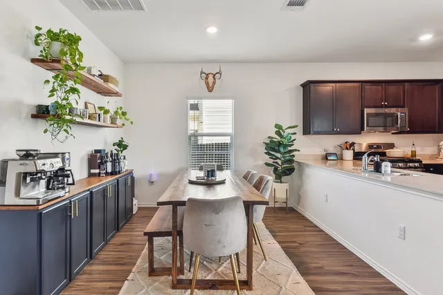 a kitchen with granite countertop lots of counter top space a sink and appliances