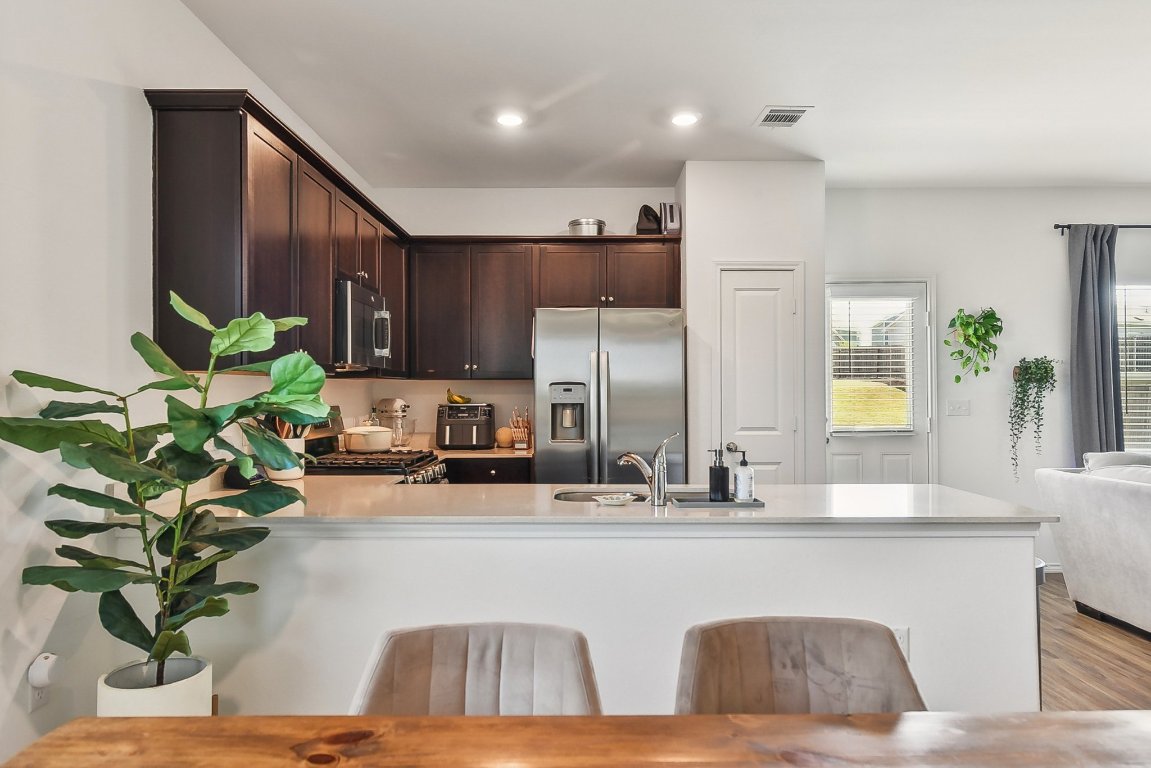 5908 Eden Drive Austin, TX 78747 - Photo 10 of 31 a view of kitchen with kitchen island a potted plant and a window