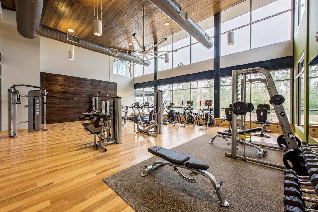 4022 Sabine Valley Trail Spring, TX 77386 - Photo 41 of 46 Modern community fitness center featuring a spacious open layout, soaring ceilings, and an impressive wall of windows that fill the space with natural light. Equipped with both cardio and strength-training equipment, this well-appointed amenity offers residents a convenient place to stay active and healthy close to home.