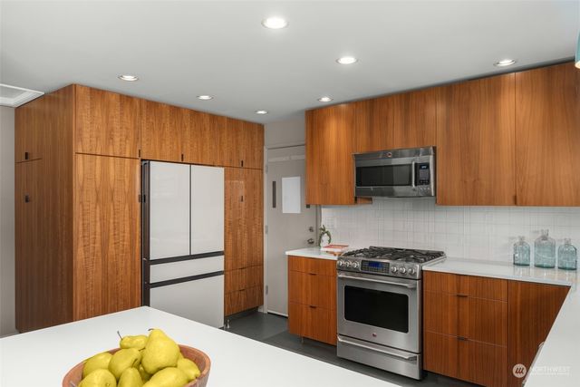 a kitchen with stainless steel appliances a stove a microwave and a refrigerator