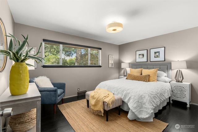 a bedroom with a bed a dresser and chair