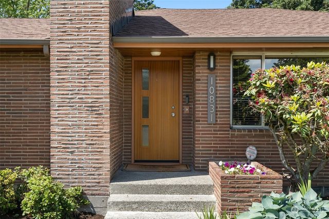 a front view of a house with plants