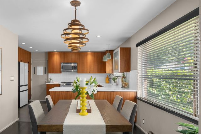 a dining room with furniture and window