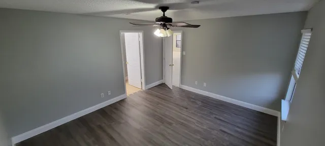 wooden floor in an empty room with a window