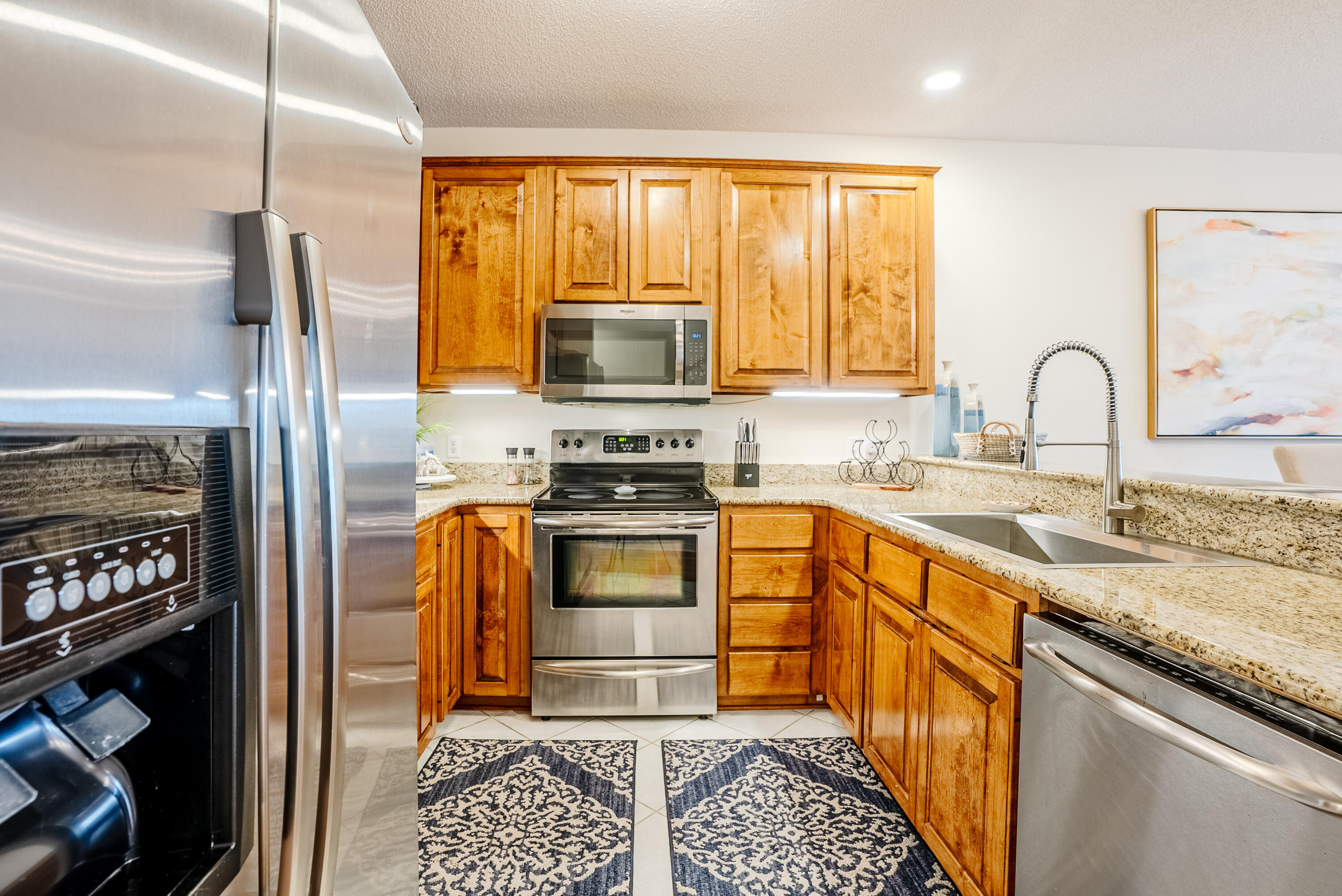10 Mar-A-Lago Boulevard, Unit 14 Santa Rosa Beach, FL 32459 - Photo 11 of 47 a kitchen with stainless steel appliances granite countertop a stove a sink and a refrigerator