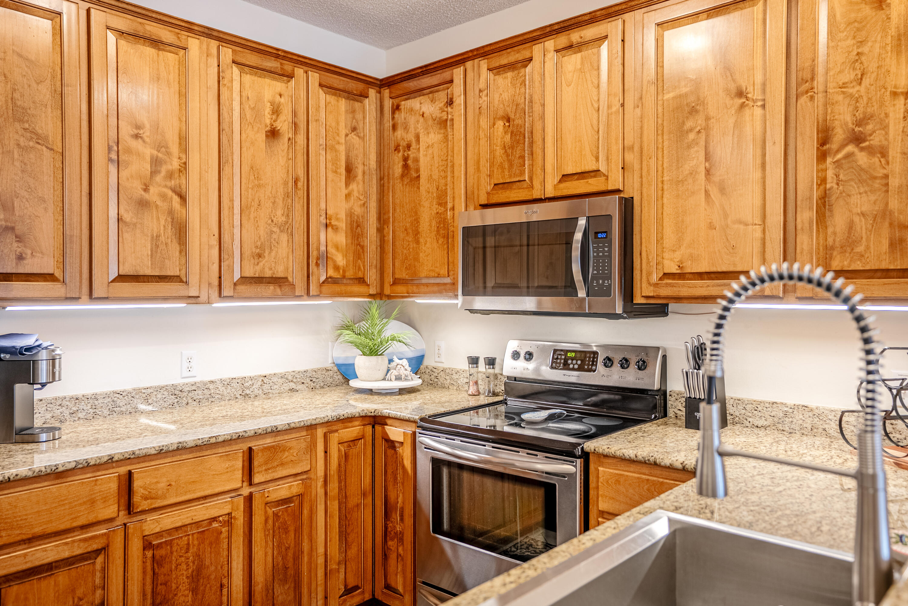 10 Mar-A-Lago Boulevard, Unit 14 Santa Rosa Beach, FL 32459 - Photo 13 of 47 a kitchen with stainless steel appliances granite countertop a stove a sink and a microwave