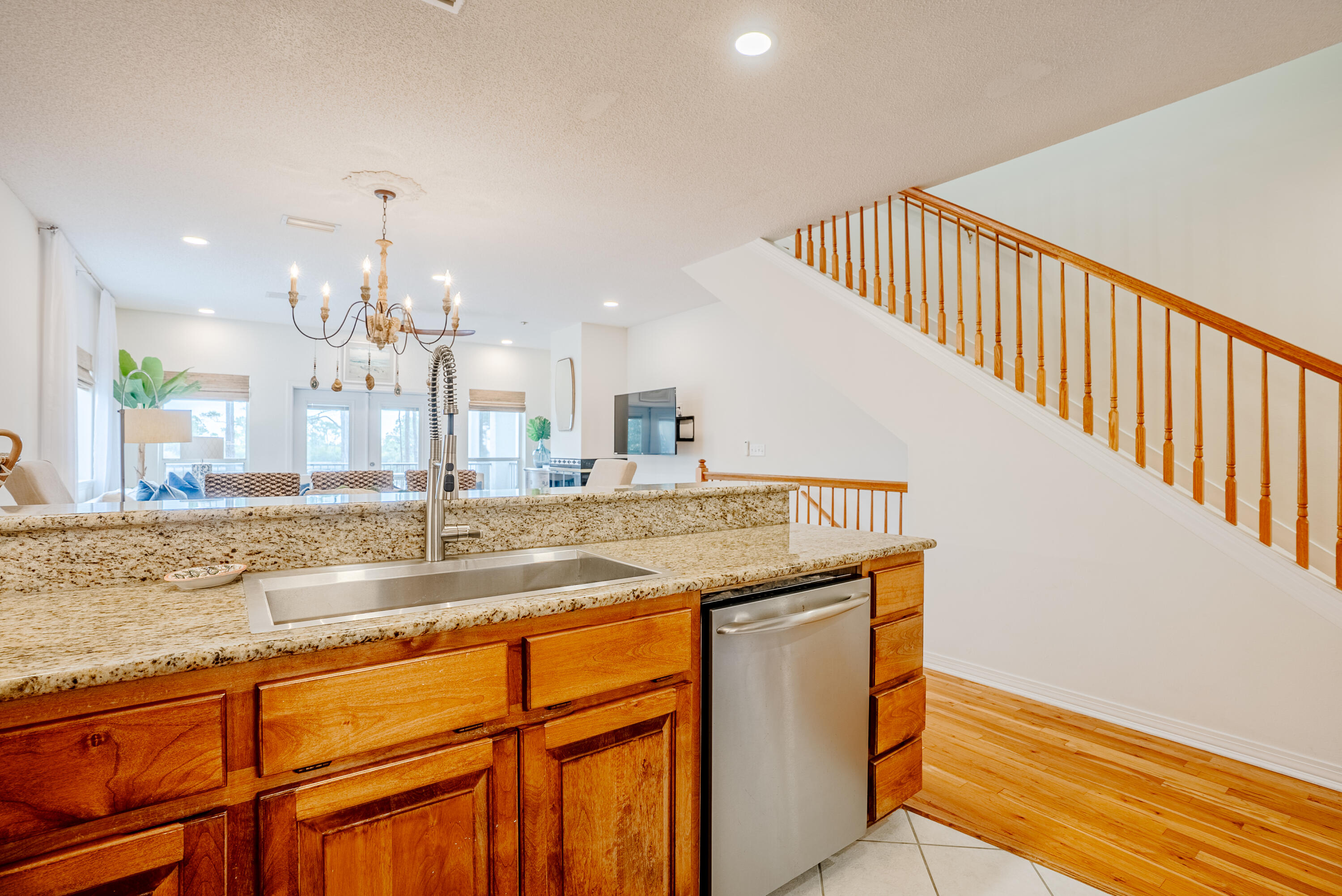 10 Mar-A-Lago Boulevard, Unit 14 Santa Rosa Beach, FL 32459 - Photo 14 of 47 a view of a kitchen with kitchen island a sink wooden floor and a chandelier