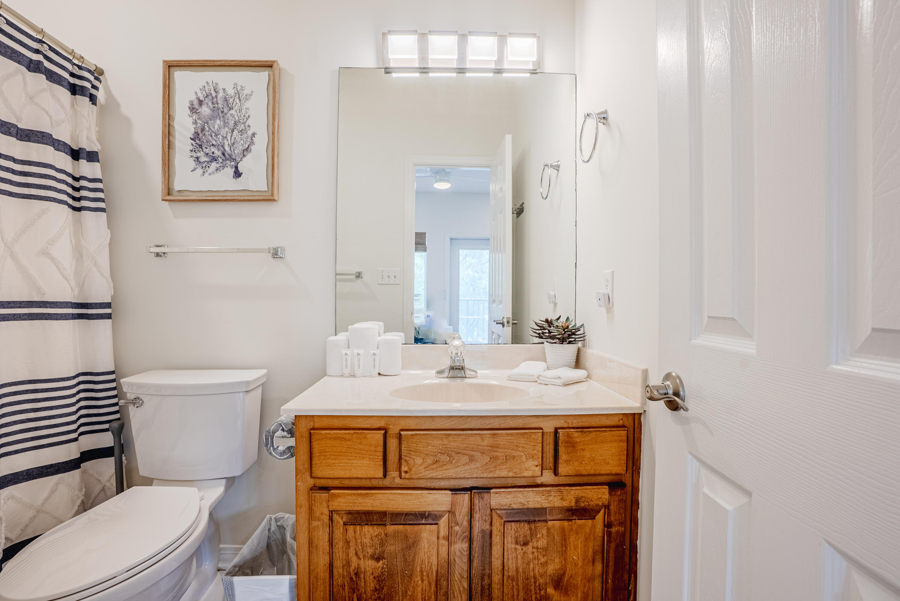 10 Mar-A-Lago Boulevard, Unit 14 Santa Rosa Beach, FL 32459 - Photo 27 of 47 a bathroom with a sink toilet and mirror