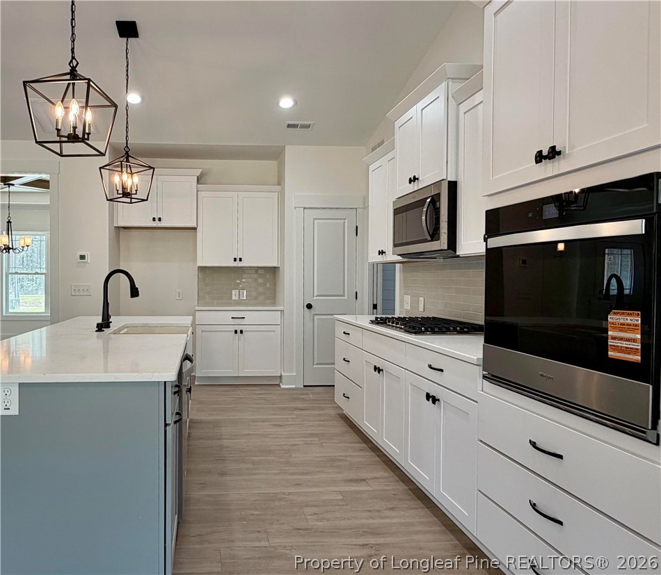 1788 Alderman Mill Road Dunn, NC 28334 - Photo 7 of 14 a kitchen with stainless steel appliances granite countertop a sink and stove