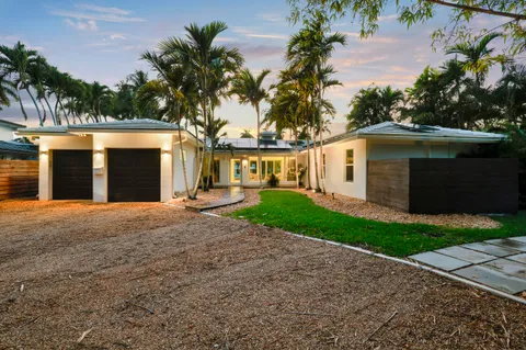 a front view of a house with a yard and a garage