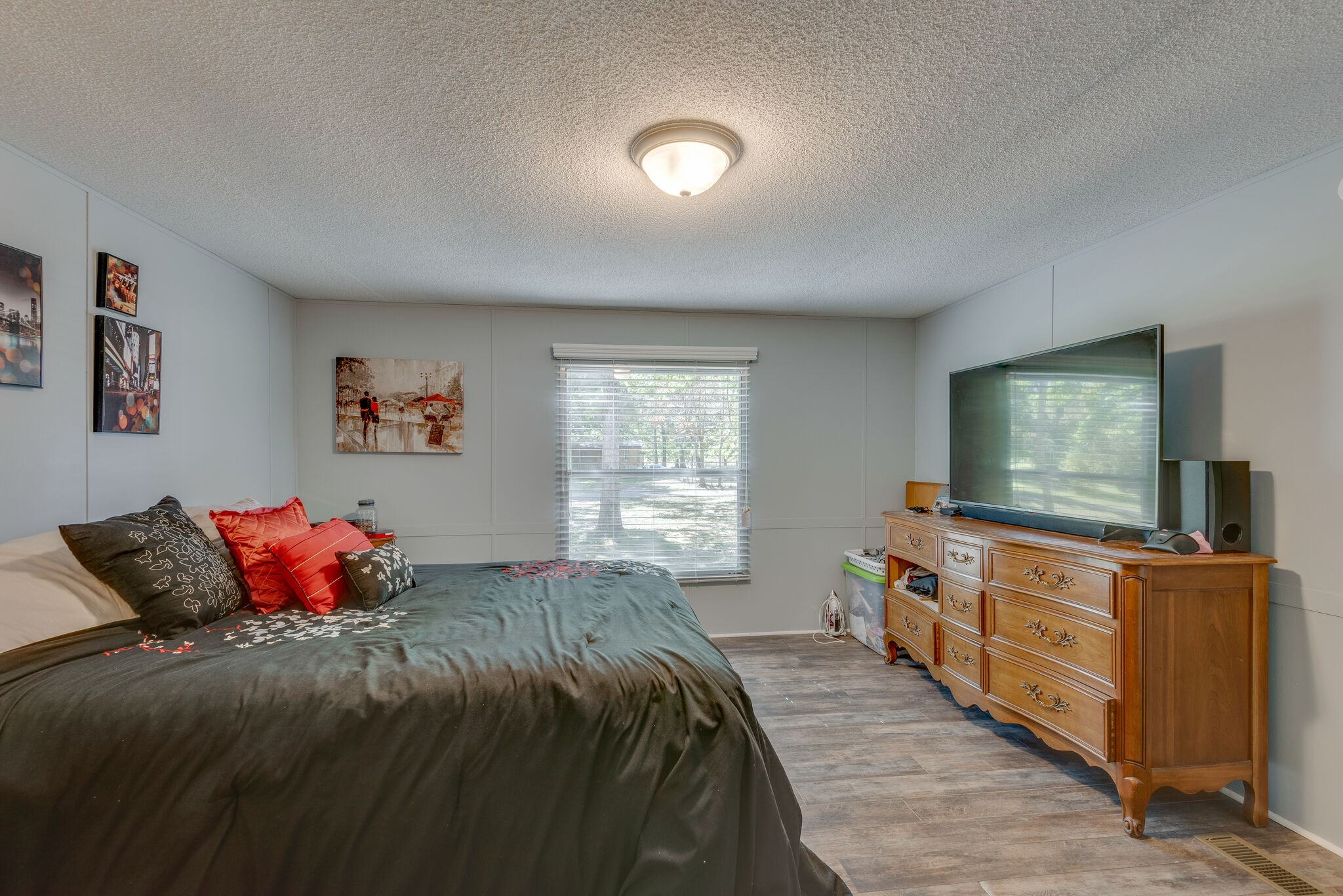 176 Duke Road Dickson, TN 37055 - Photo 17 of 26 a bedroom with a bed and a flat screen tv