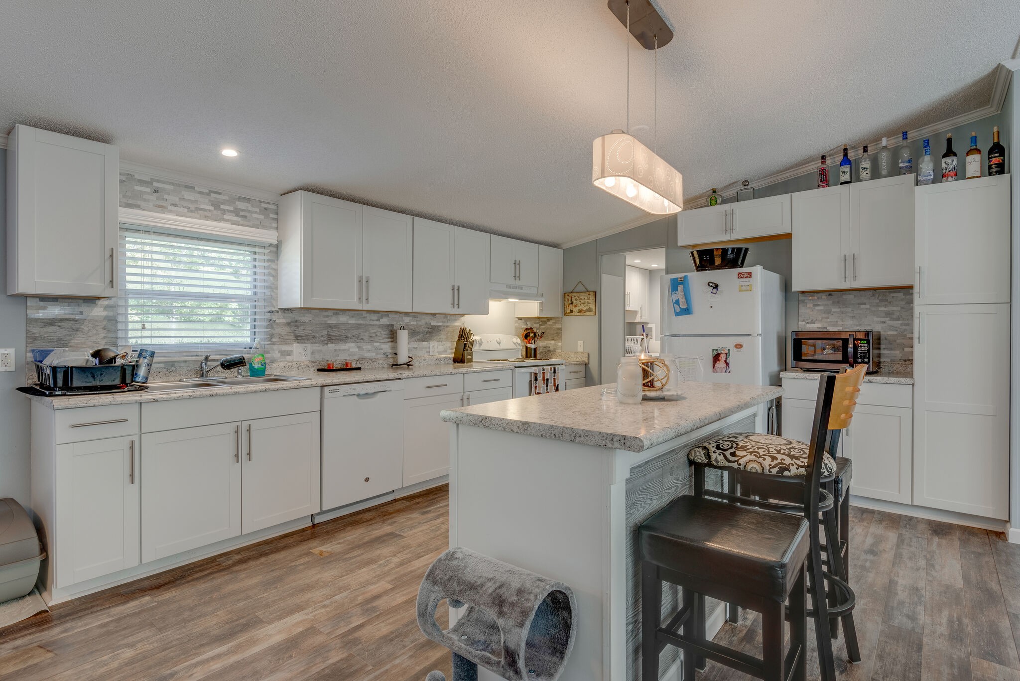176 Duke Road Dickson, TN 37055 - Photo 10 of 26 a kitchen with white cabinets and chairs
