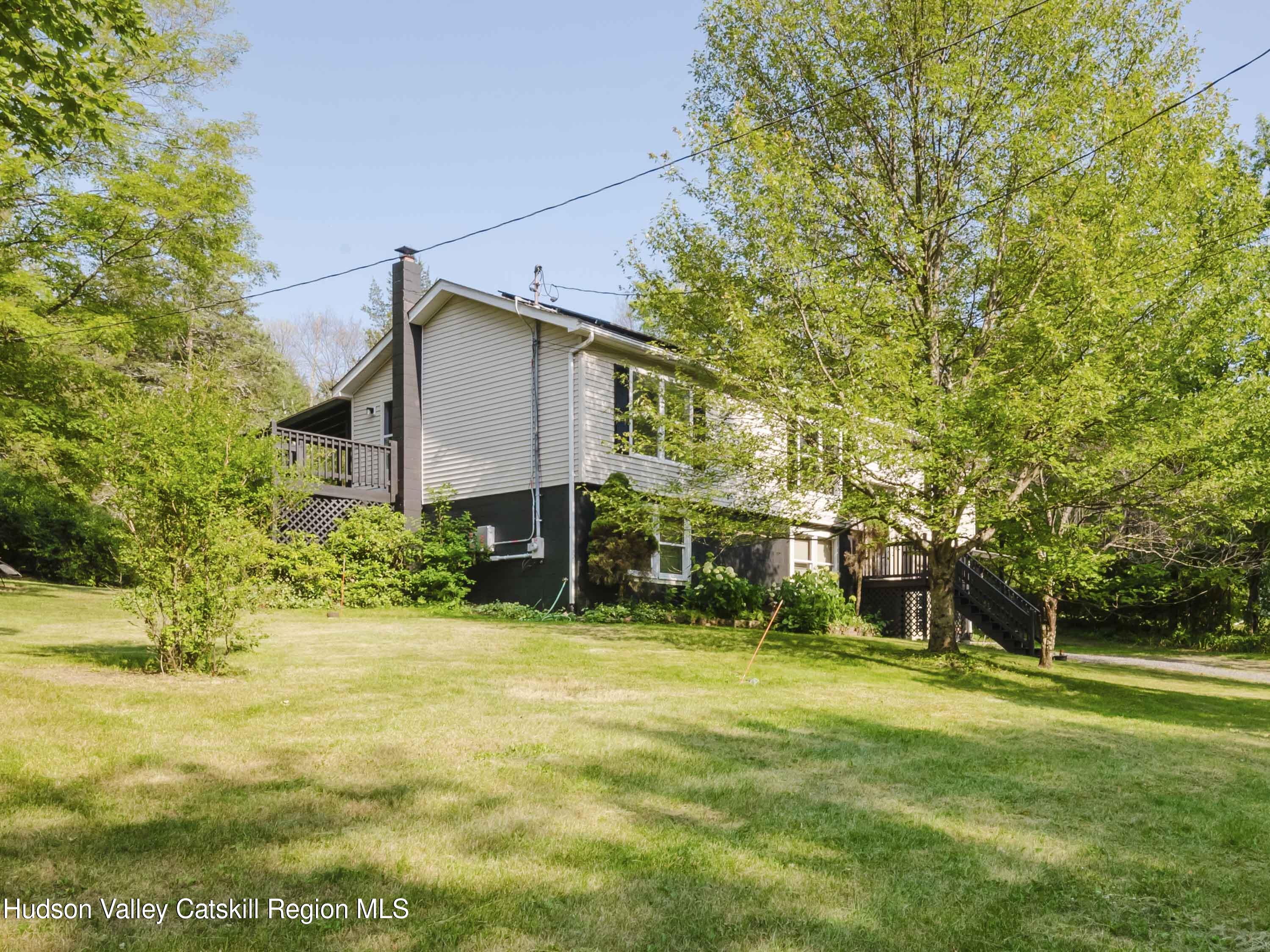 a front view of house with yard and green space