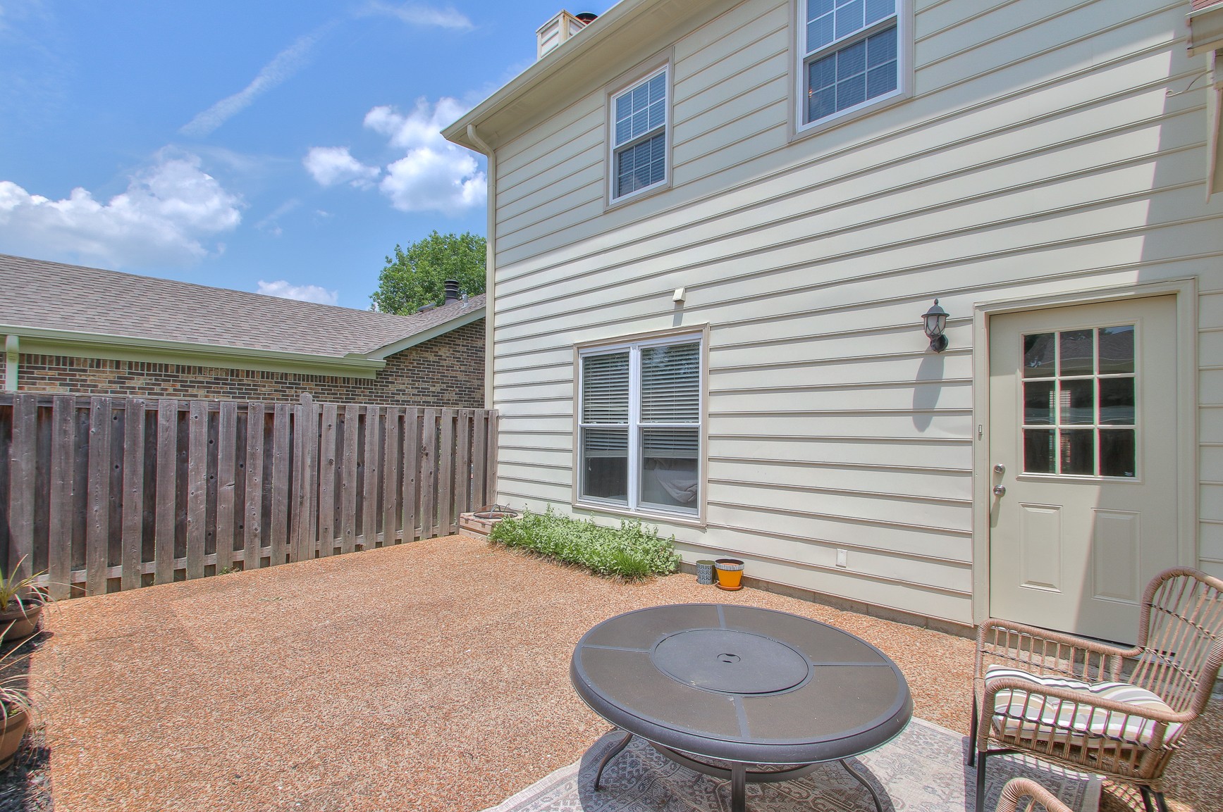 1016 General George Patton Road Nashville, TN 37221 - Photo 19 of 23 a backyard of a house with table and chairs