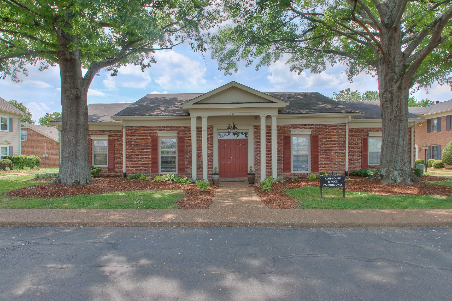 1016 General George Patton Road Nashville, TN 37221 - Photo 22 of 23 a front view of a house with a garden and trees