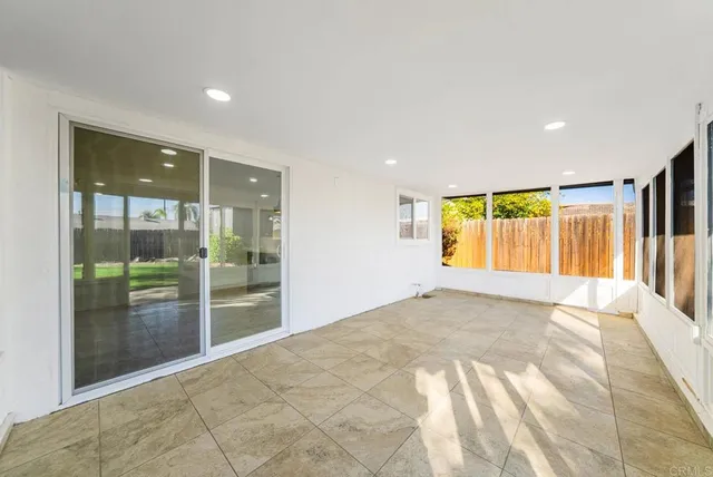 a view of an empty room with glass door