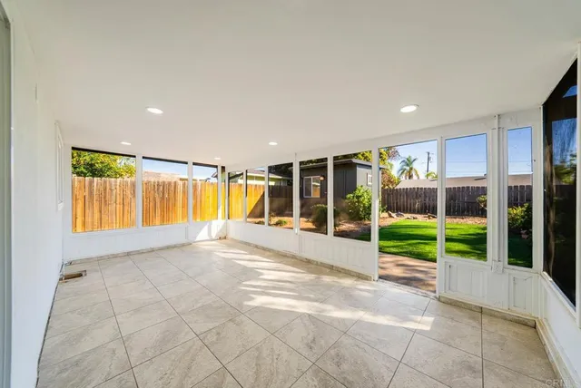 a view of a porch with a table and chairs