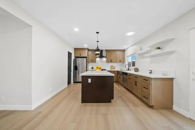a kitchen with wooden cabinets and white appliances