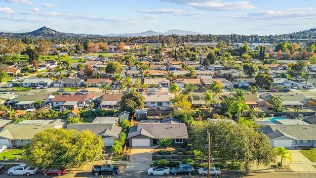 an aerial view of residential building with green space