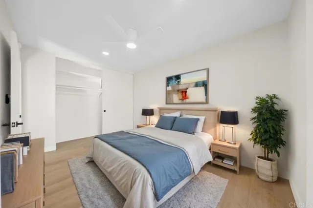a bedroom with a large bed and a potted plant