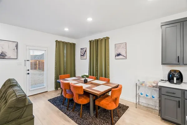 a dining room with furniture and window