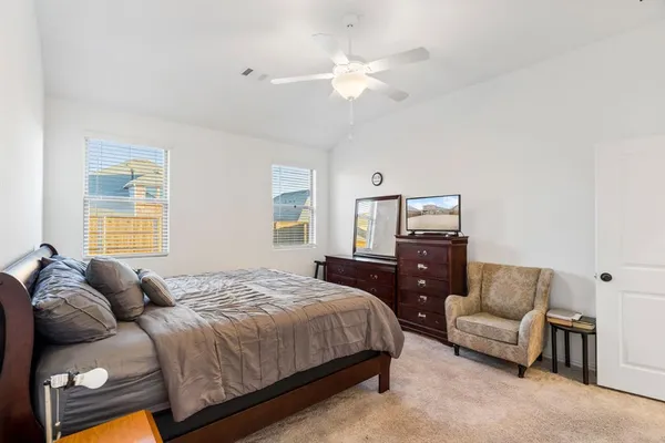 a bedroom with a bed couch and window