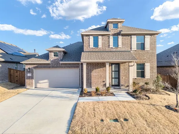 a front view of a house with yard