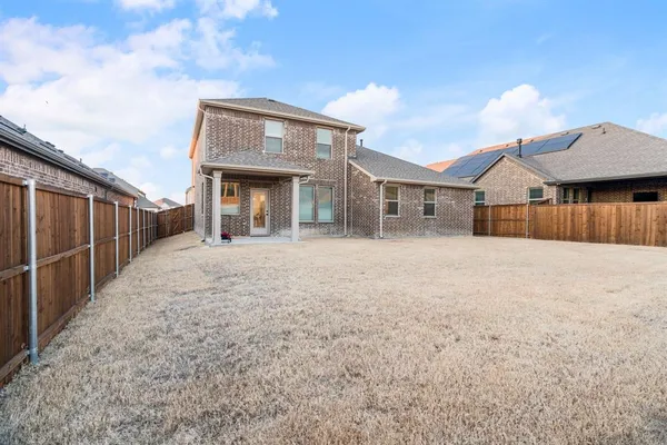 a view of a house with wooden fence