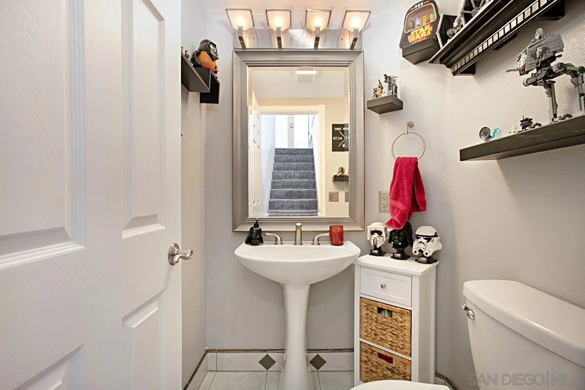 405 Whispering Willow Drive, Unit B Santee, CA 92071 - Photo 14 of 29 a bathroom with a sink vanity mirror and toilet