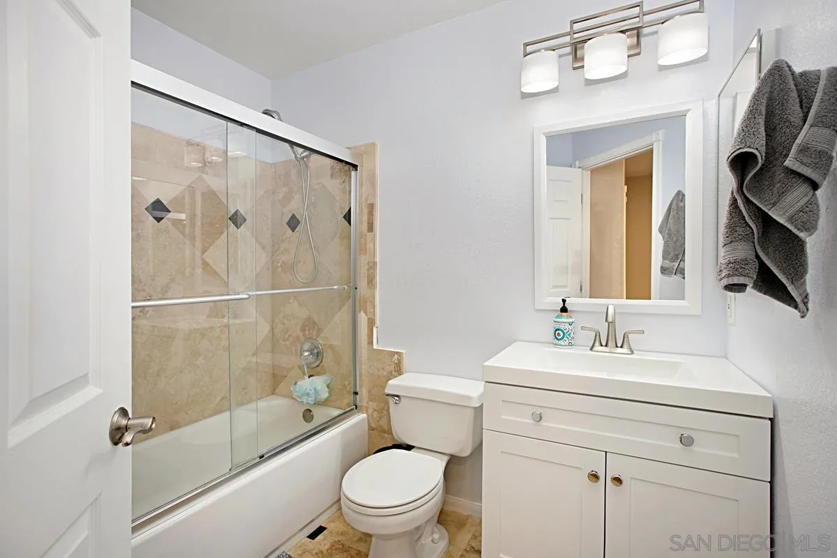 405 Whispering Willow Drive, Unit B Santee, CA 92071 - Photo 22 of 29 a bathroom with a sink a toilet and shower a mirror