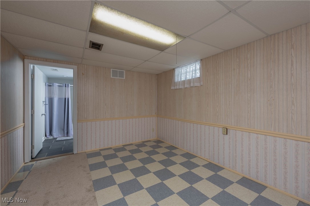 3205 Hemphill Road Barberton, OH 44203 - Photo 20 of 22 Basement with a paneled ceiling and dark colored carpet