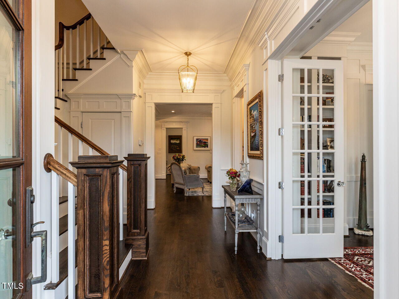 543 Guilford Circle Raleigh, NC 27608 - Photo 21 of 46 a view of a hallway with wooden floor and staircase