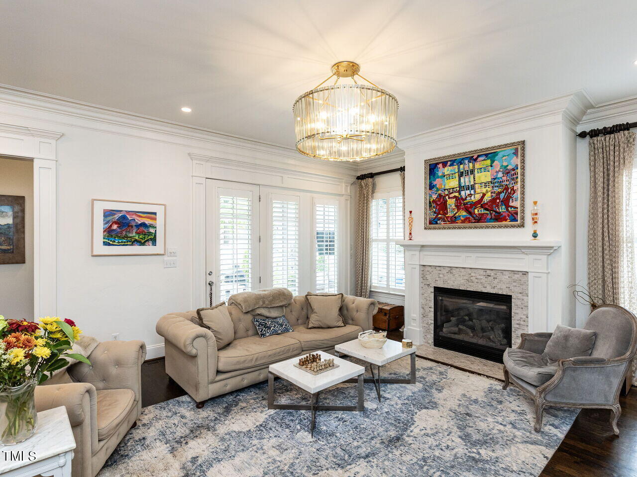 543 Guilford Circle Raleigh, NC 27608 - Photo 23 of 46 a living room with furniture chandelier and a fireplace