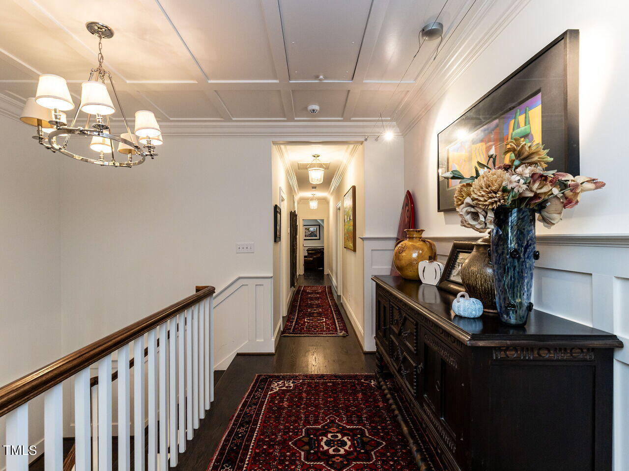 543 Guilford Circle Raleigh, NC 27608 - Photo 28 of 46 a view of a hallway with wooden floor and a chandelier