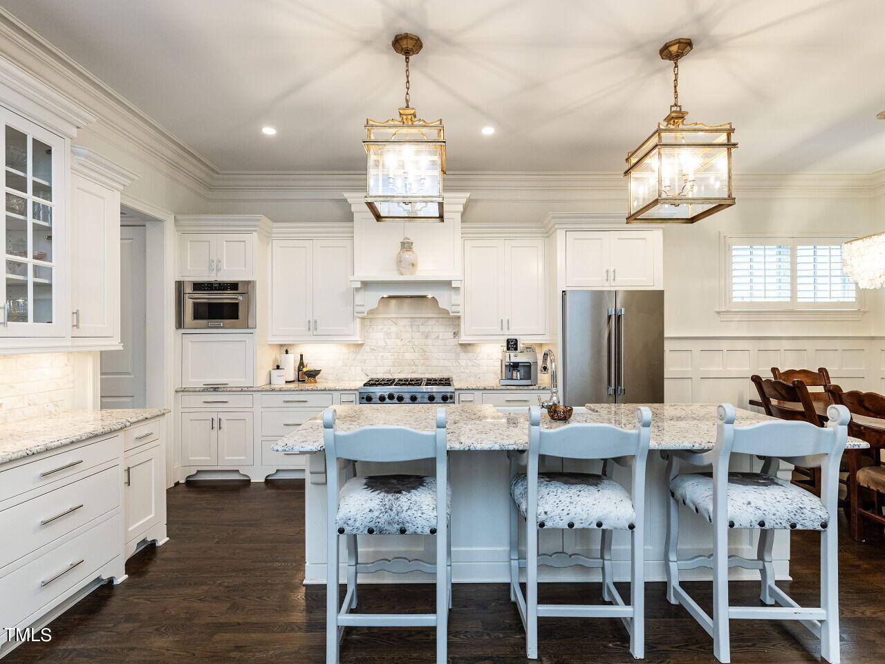 543 Guilford Circle Raleigh, NC 27608 - Photo 9 of 46 a kitchen with stainless steel appliances a stove a refrigerator and white cabinets