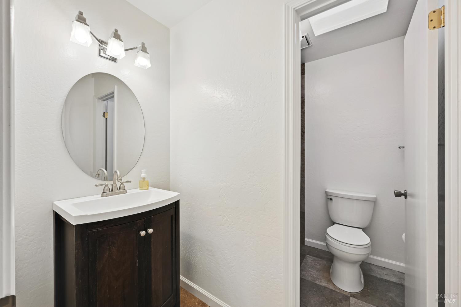 1240 North Street Santa Rosa, CA 95404 - Photo 11 of 36 a bathroom with a toilet a sink and a mirror