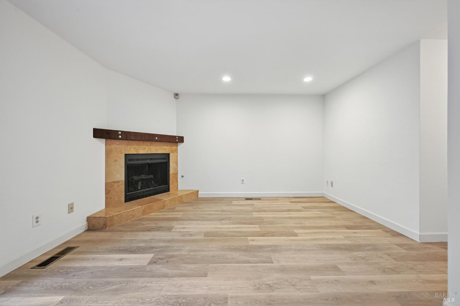 1240 North Street Santa Rosa, CA 95404 - Photo 14 of 36 a view of empty room with wooden floor and fireplace