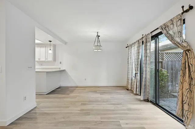 a view of an entryway with wooden floor and door