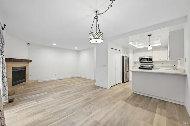 a view of a kitchen with refrigerator and cabinets