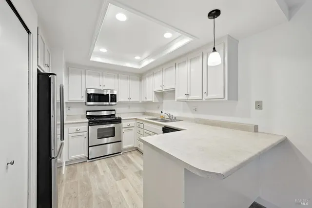 a kitchen with a stove a sink and a refrigerator